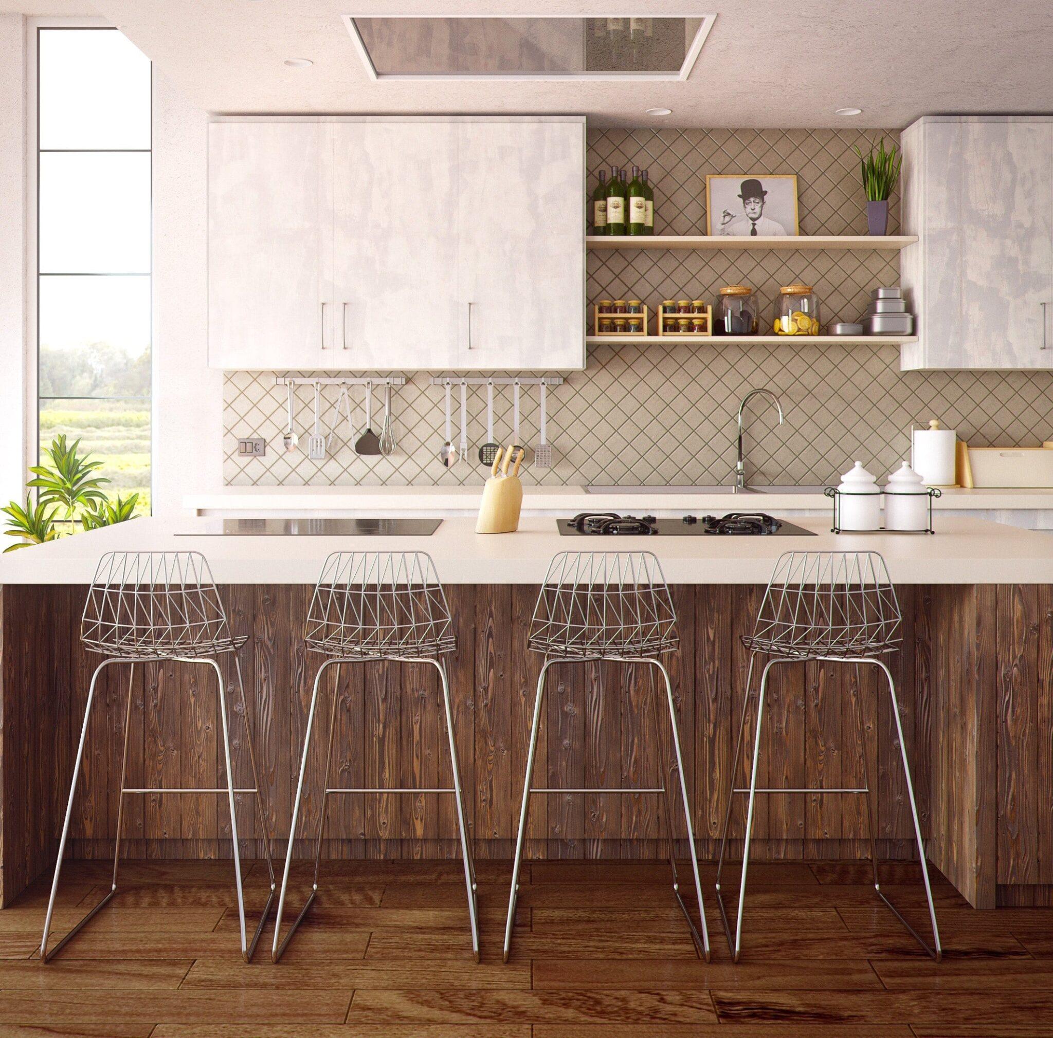 Light and airy modern kitchen featuring barstools and pendant lighting.