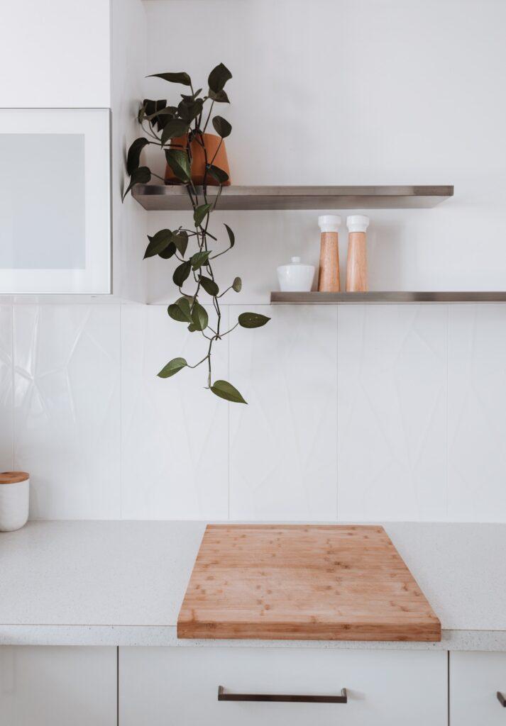 Floating shelf with minimalist decor in a clean kitchen setting.