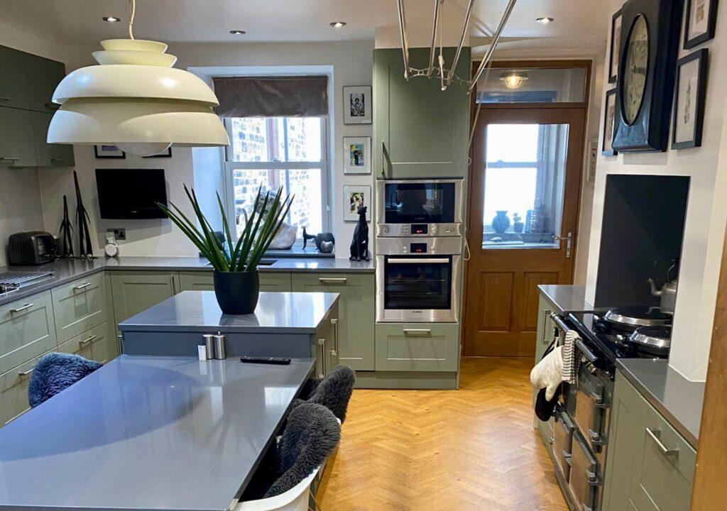 Cosy traditional kitchen with wooden units, tiled flooring, and classic worktops